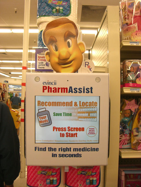 a sign advertising pharm assist and other items in the background