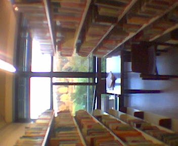 an old school liry with bookshelves and windows