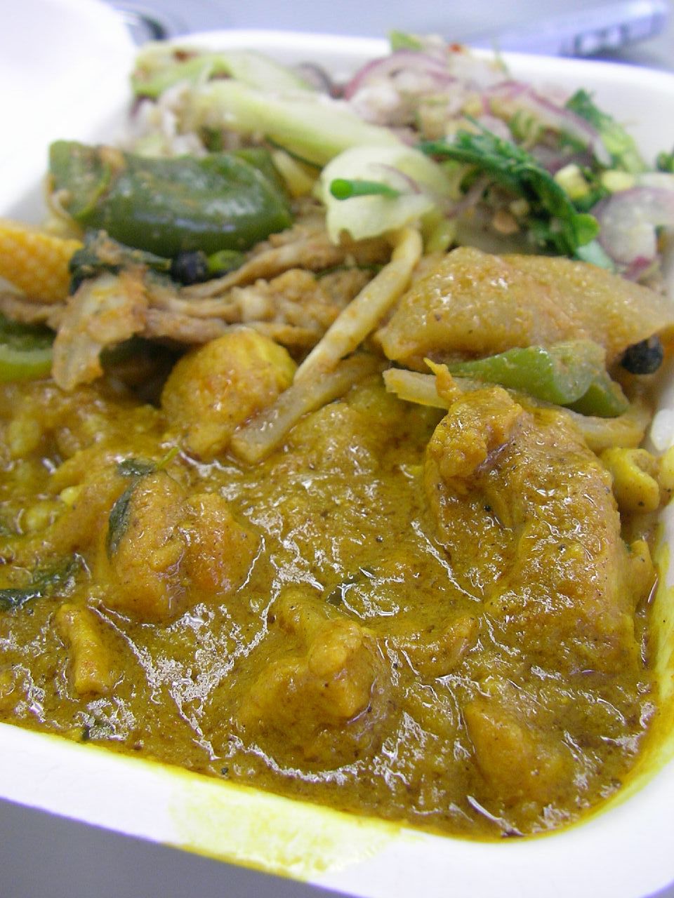 a white container filled with food next to vegetables and meat