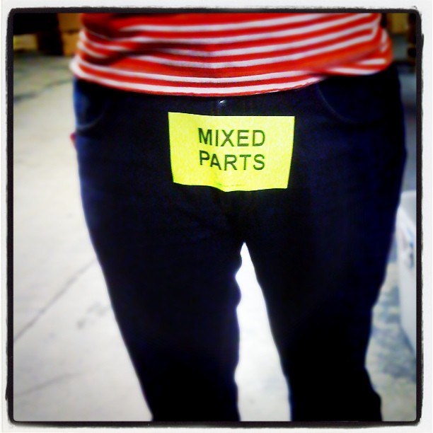 a person with a card in his pants saying mixed parts
