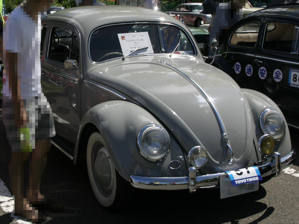 a grey old car is on display at a car show