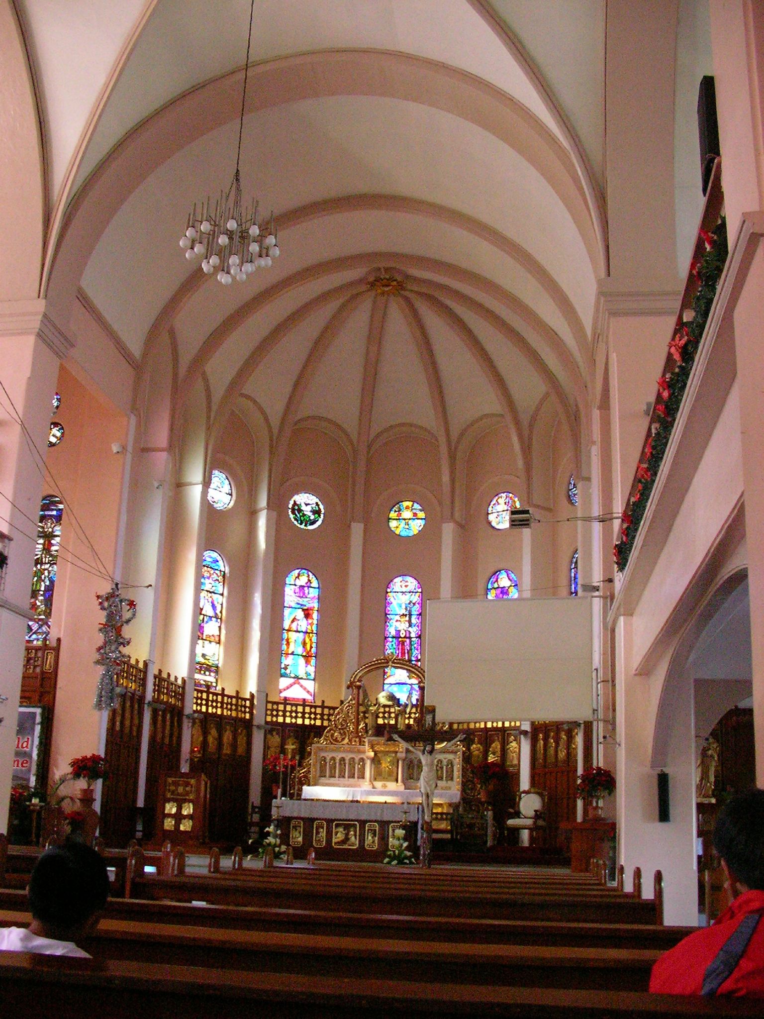 an empty church with high vaulted ceilings and stained glass