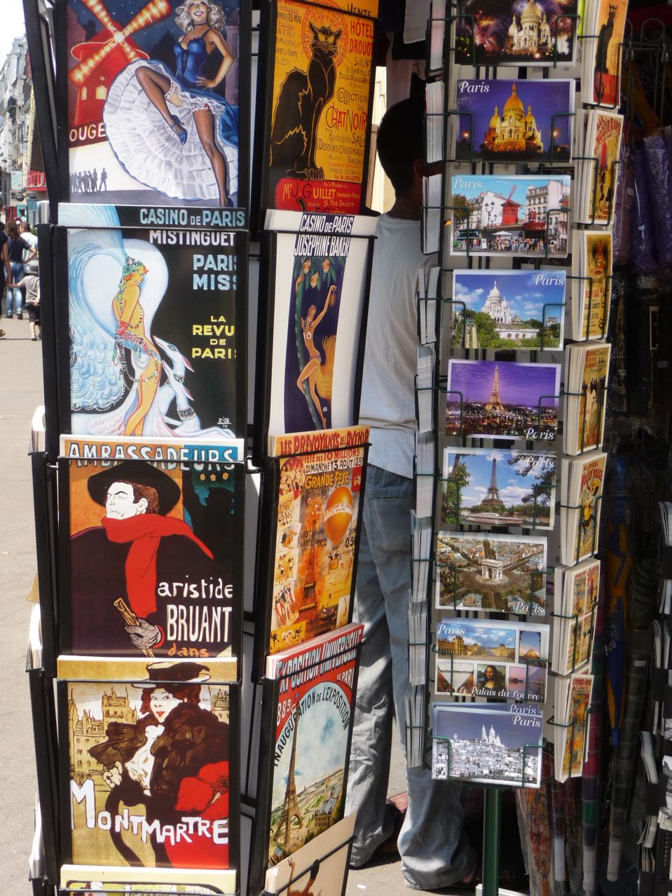 a person standing next to a pole holding a large pile of books