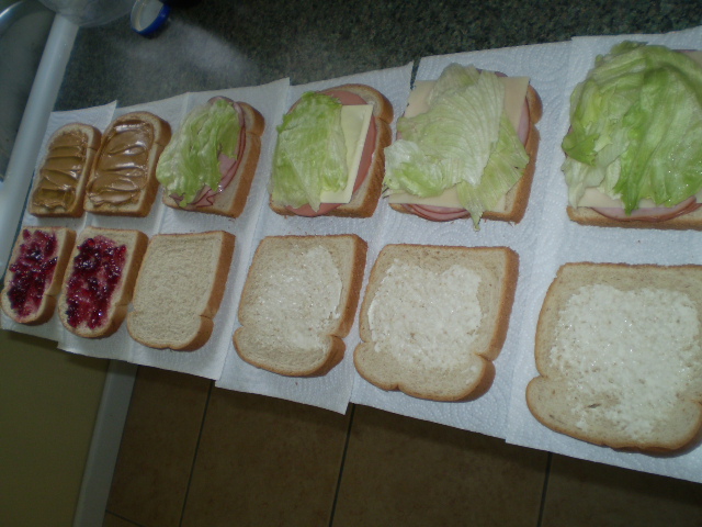 sandwich trays are lined up on a counter