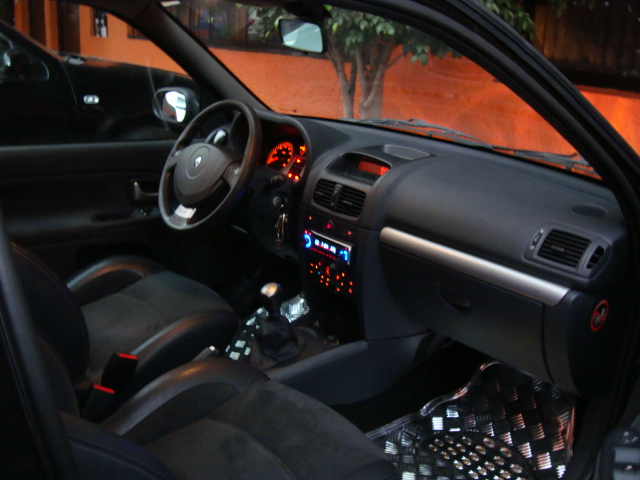 the dashboard of a black car with electronic screen