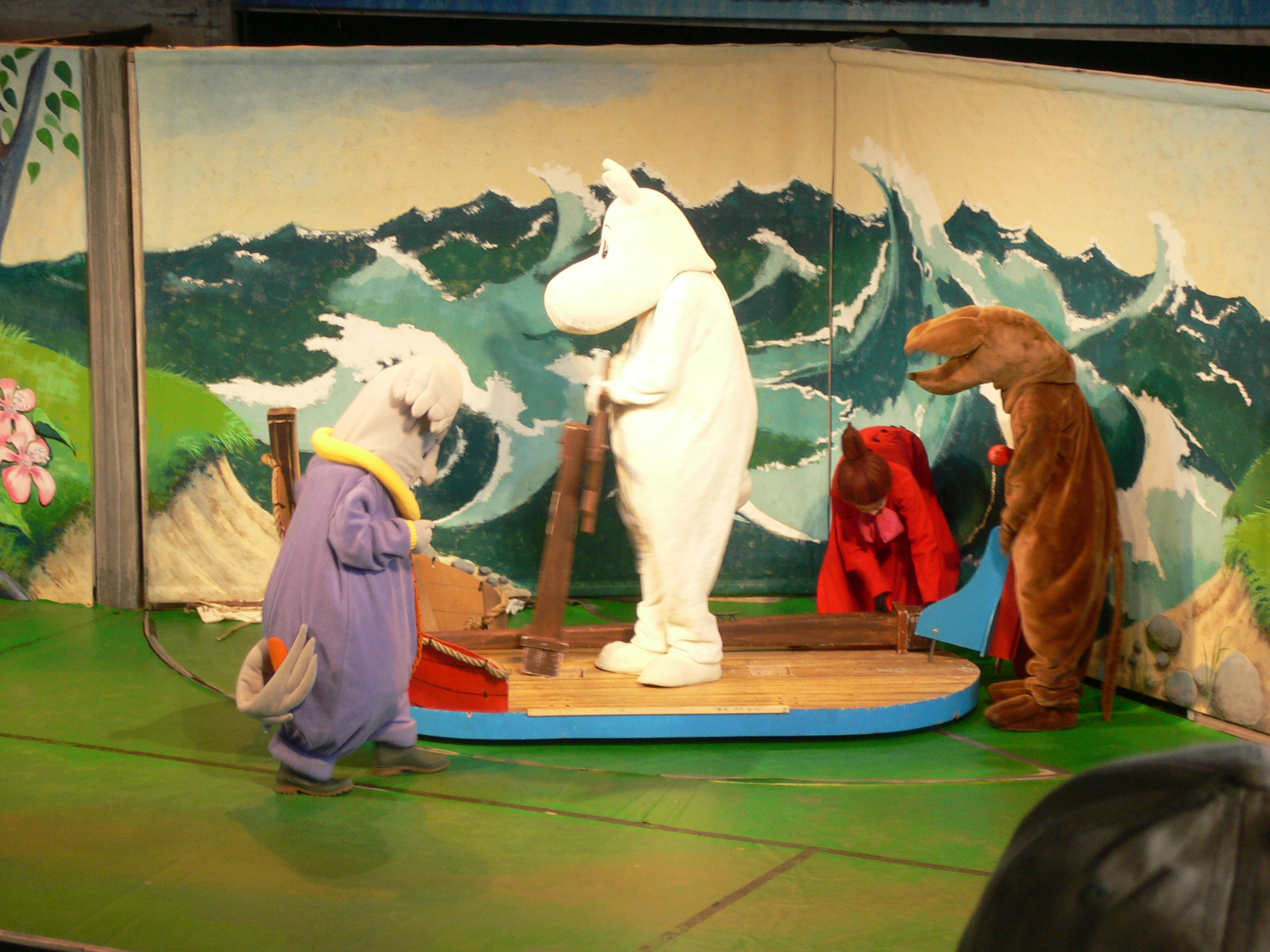 puppet show in the middle of a set and showing a white dog in the center