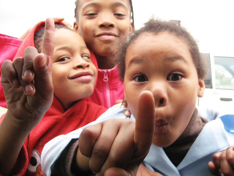 three little s holding their hands up to the camera