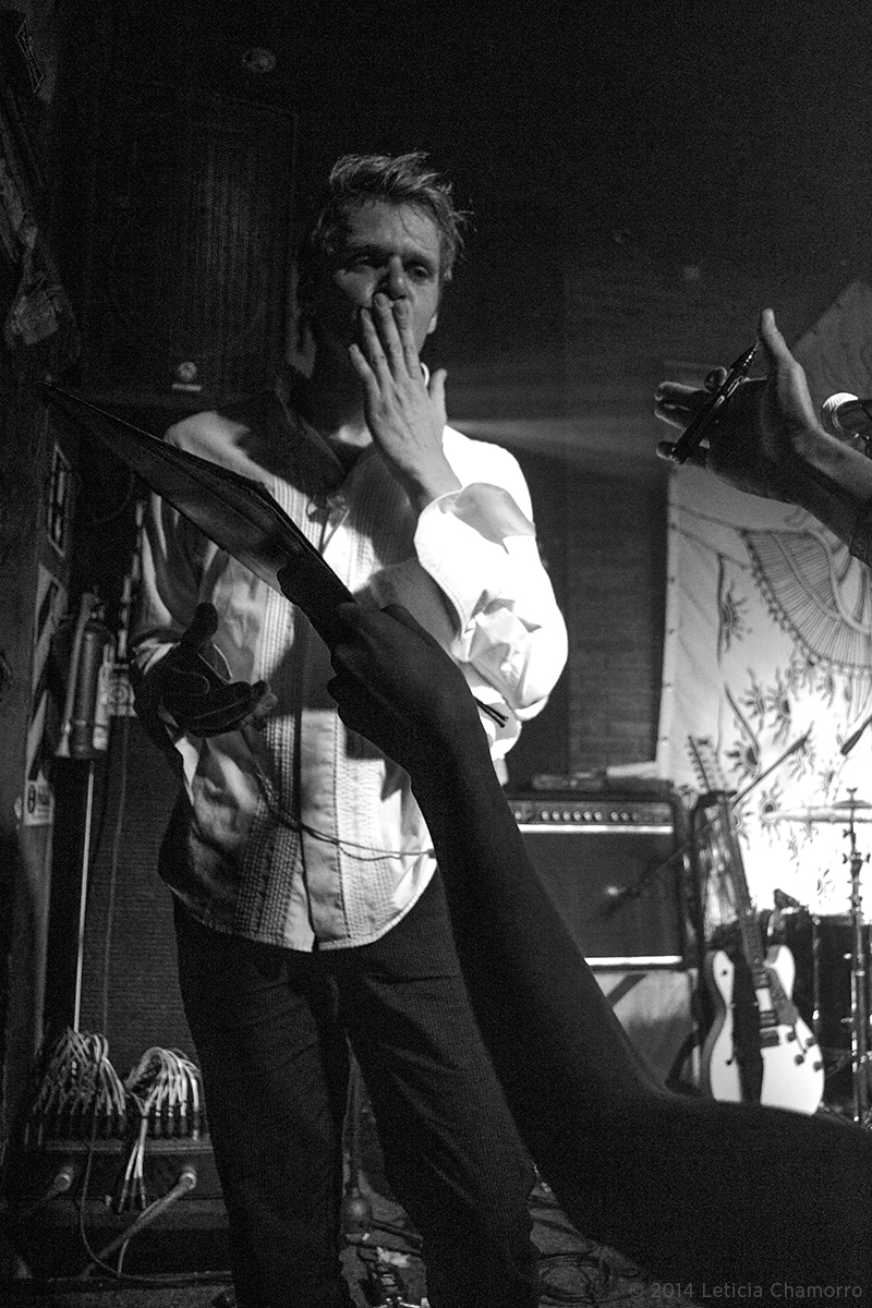 black and white pograph of a musician taking a cell phone call