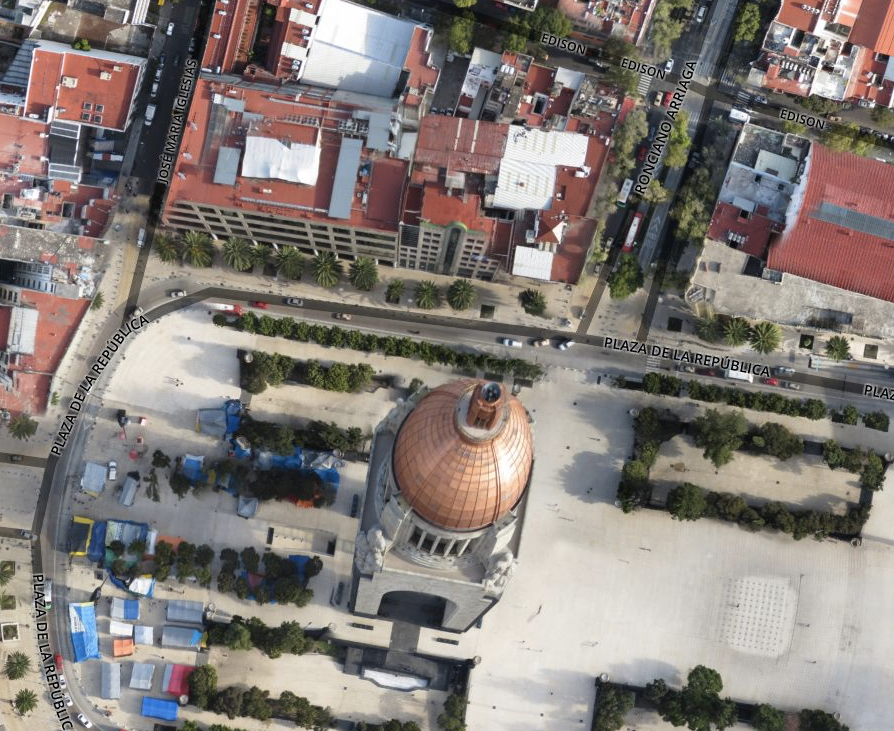 an aerial s of a cityscape showing the roof and dome of a building