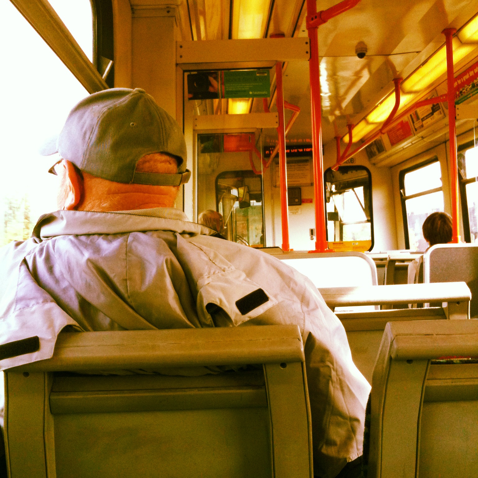 a man is sitting in the middle of a bus