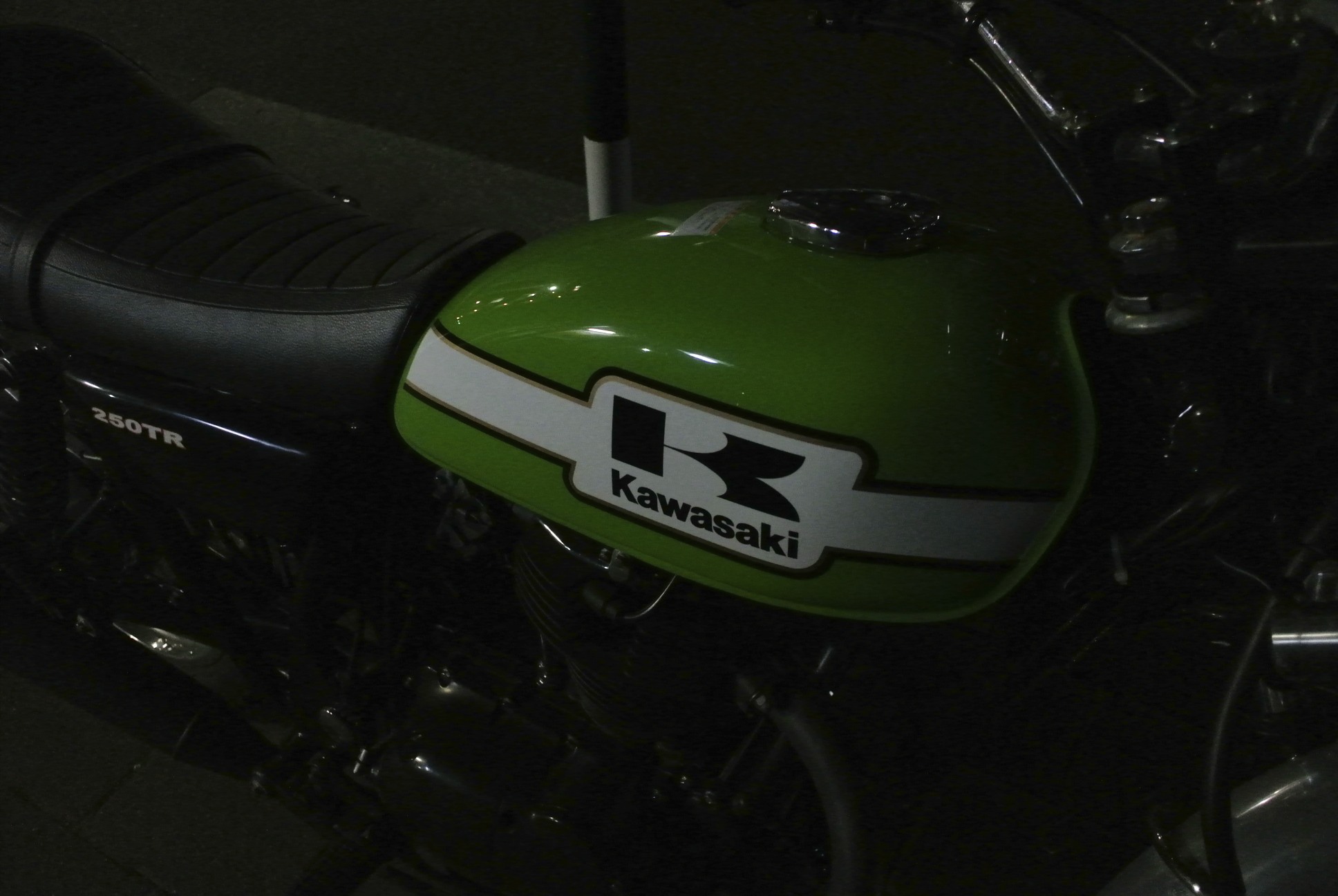 the side view of a motorcycle with its green helmet