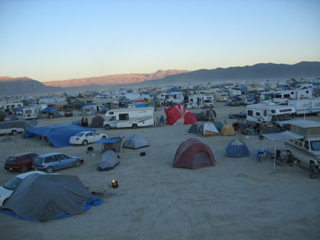 several tents are pitched up on the sandy beach