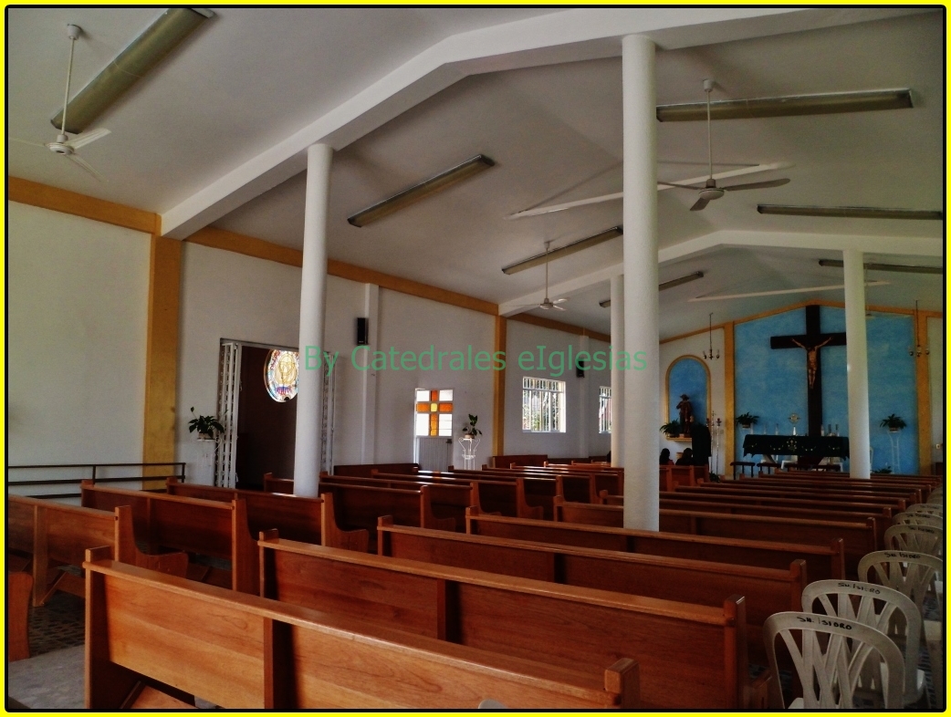 large empty church with high ceilings and rows of pews