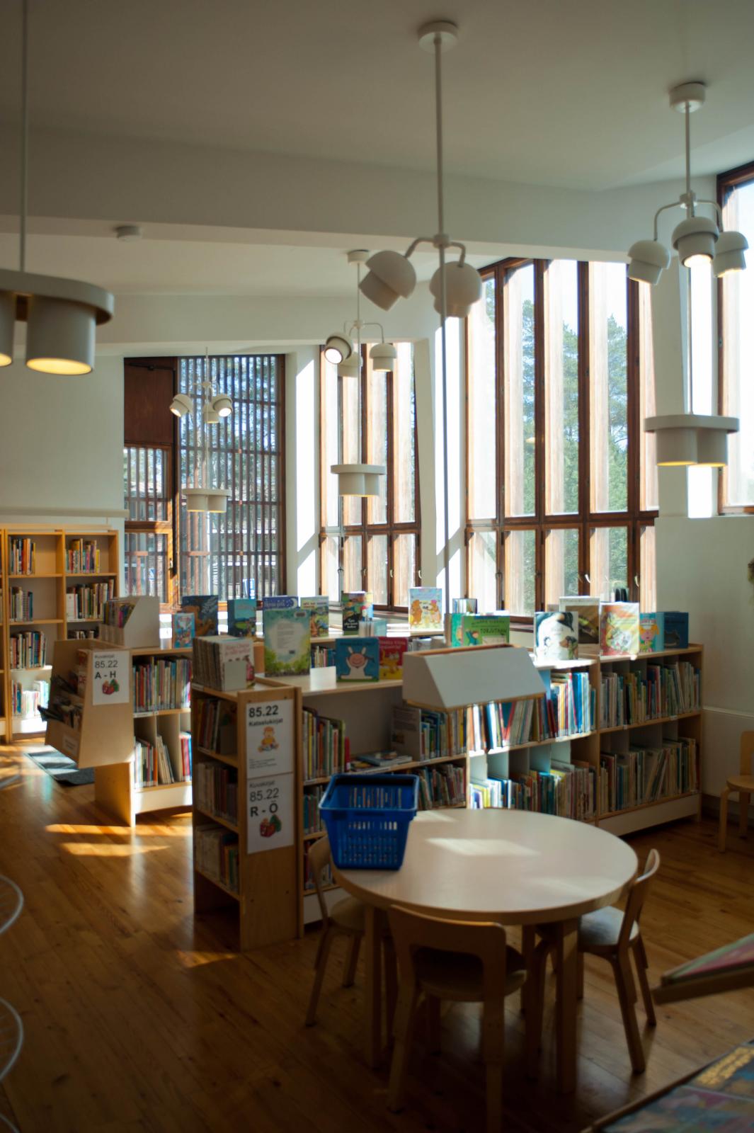 an open living area with a circular table and a bunch of books