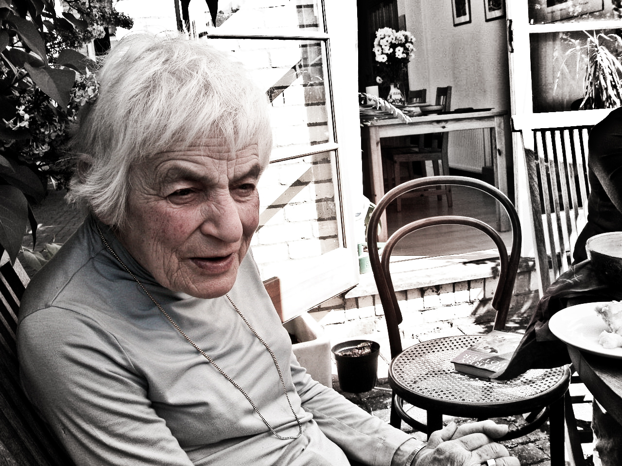 black and white po of an elderly woman on porch chair