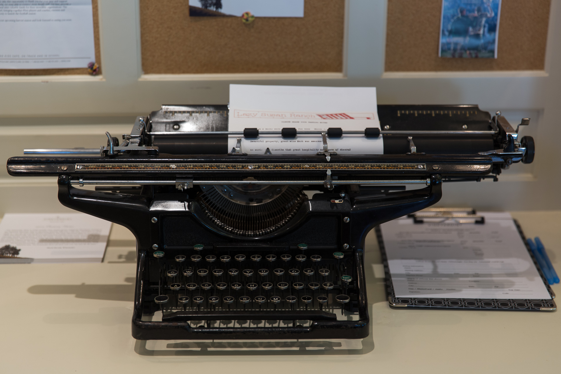 an old fashioned typewriter with paper and pen on the table