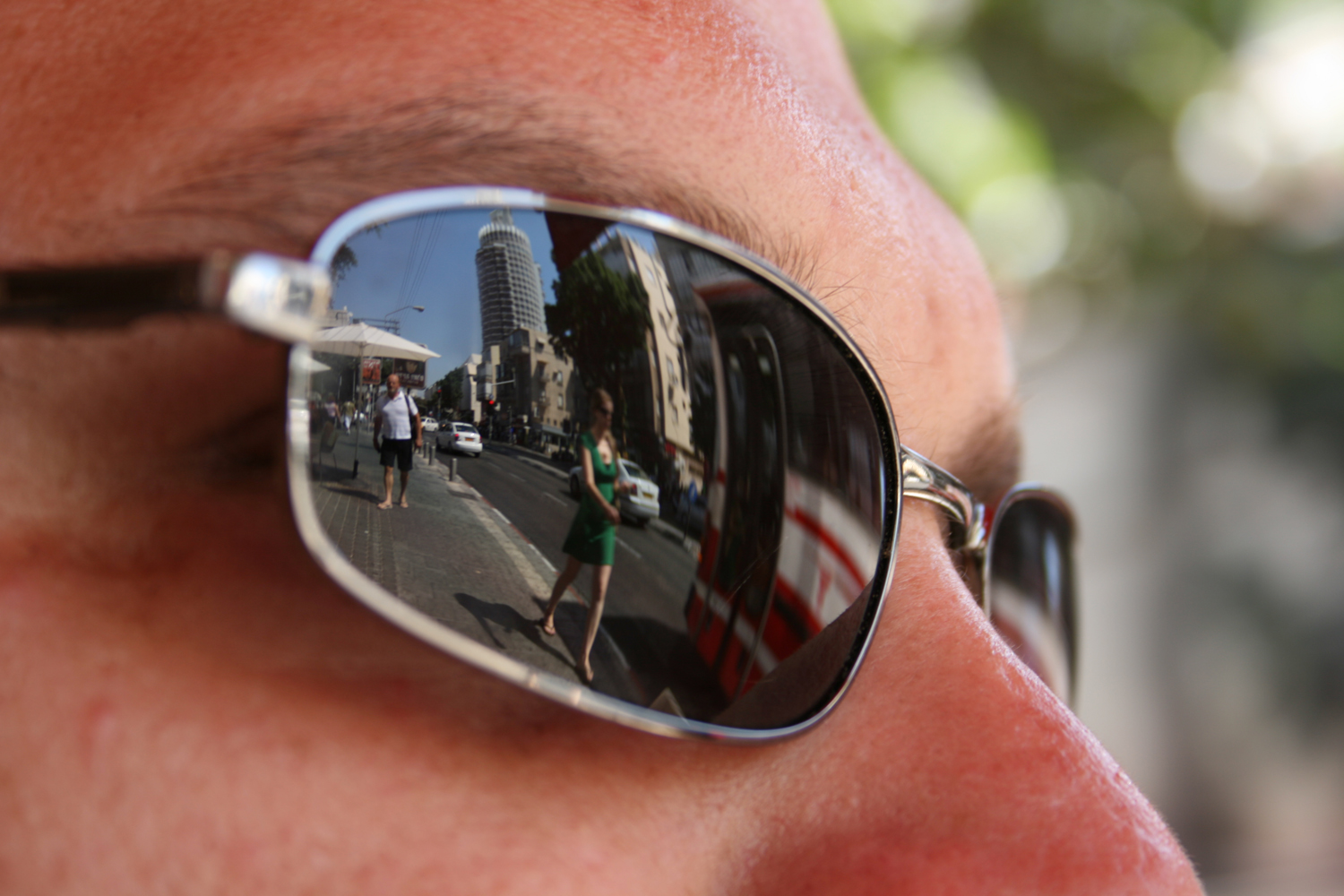 a closeup of a person with a pair of sunglasses on