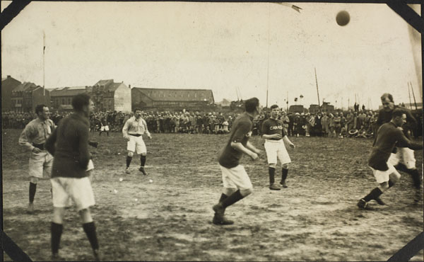vintage pograph of men playing soccer with other men