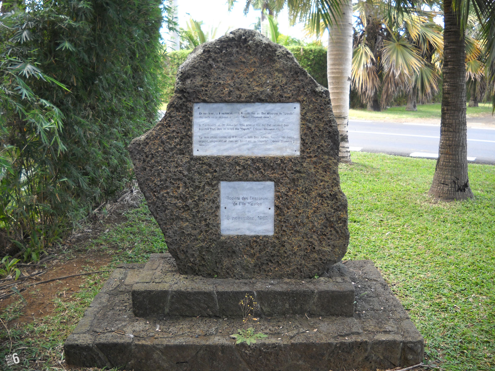 two inscribed plaques placed next to each other on cement