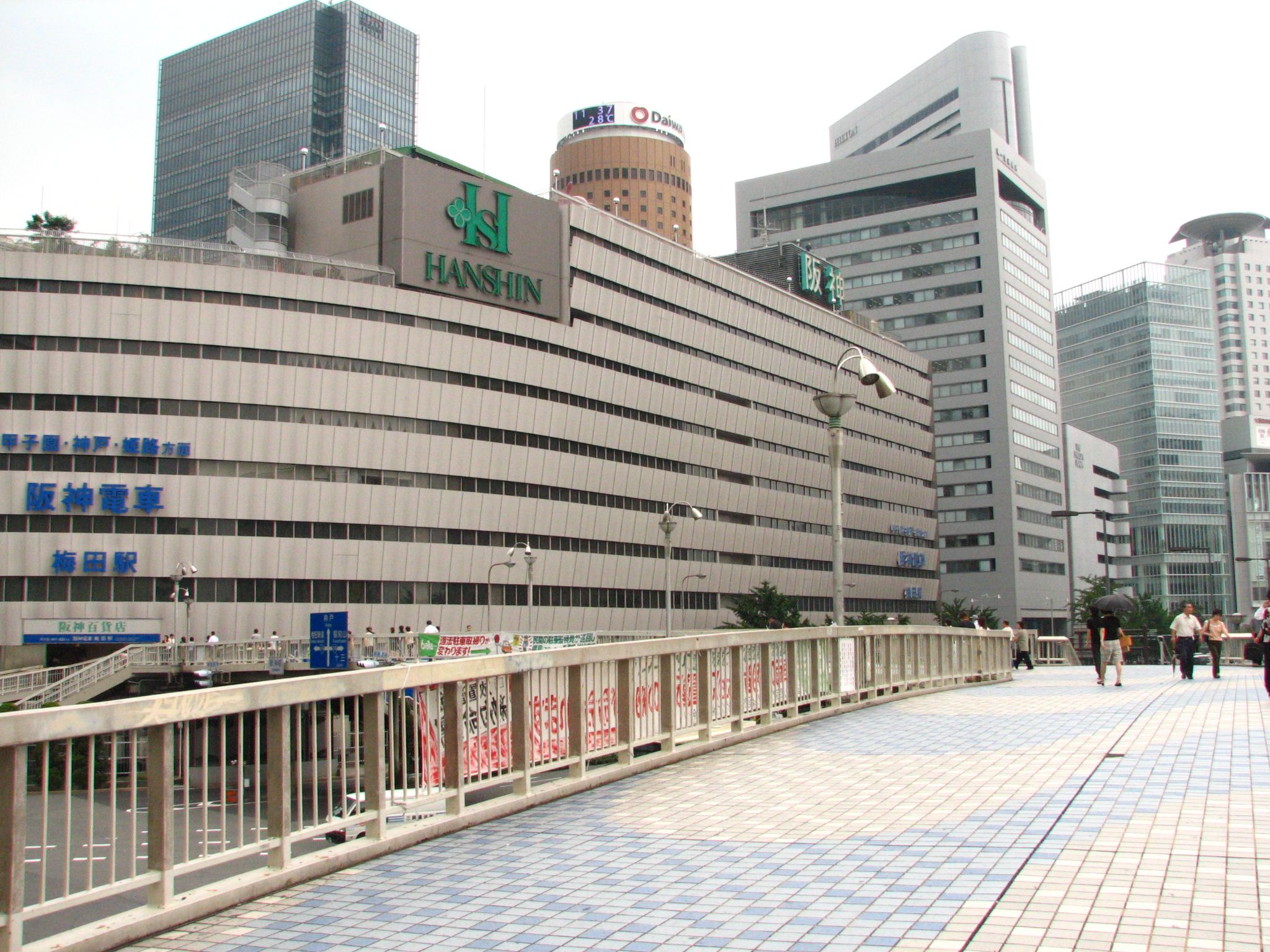several buildings in the background and a walkway next to them