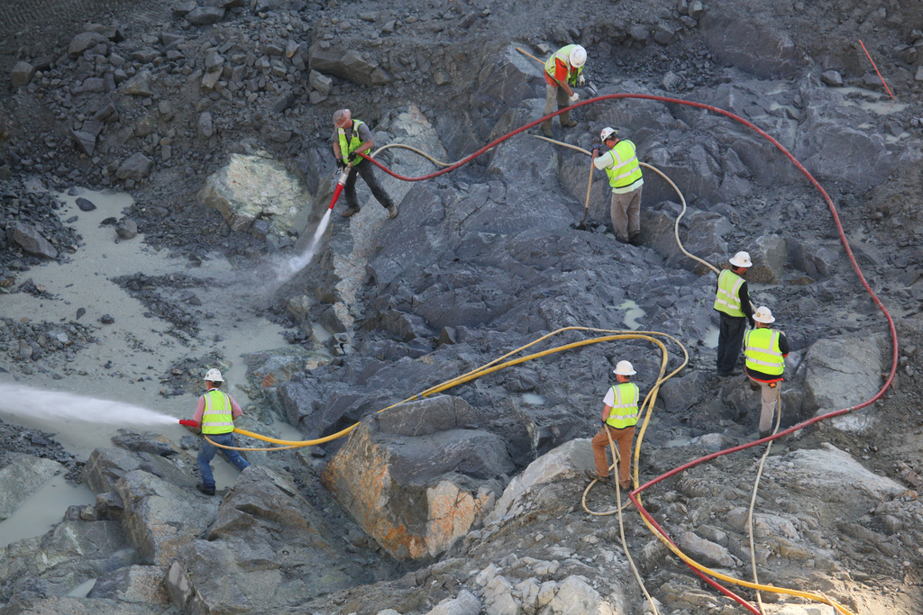 several men are doing maintenance in a quarry