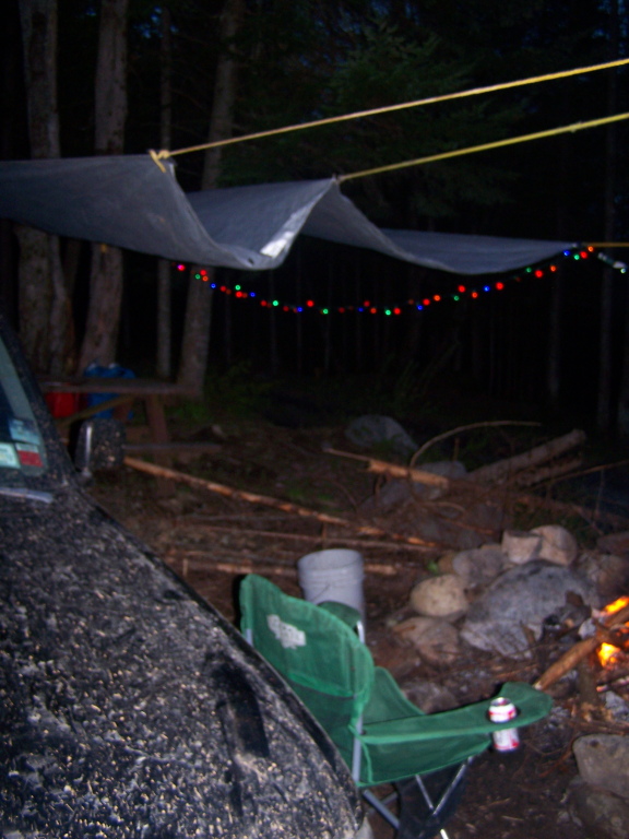 a lawn chair sitting next to a camp fire