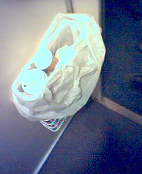 a bag sitting on a counter with white paper around it