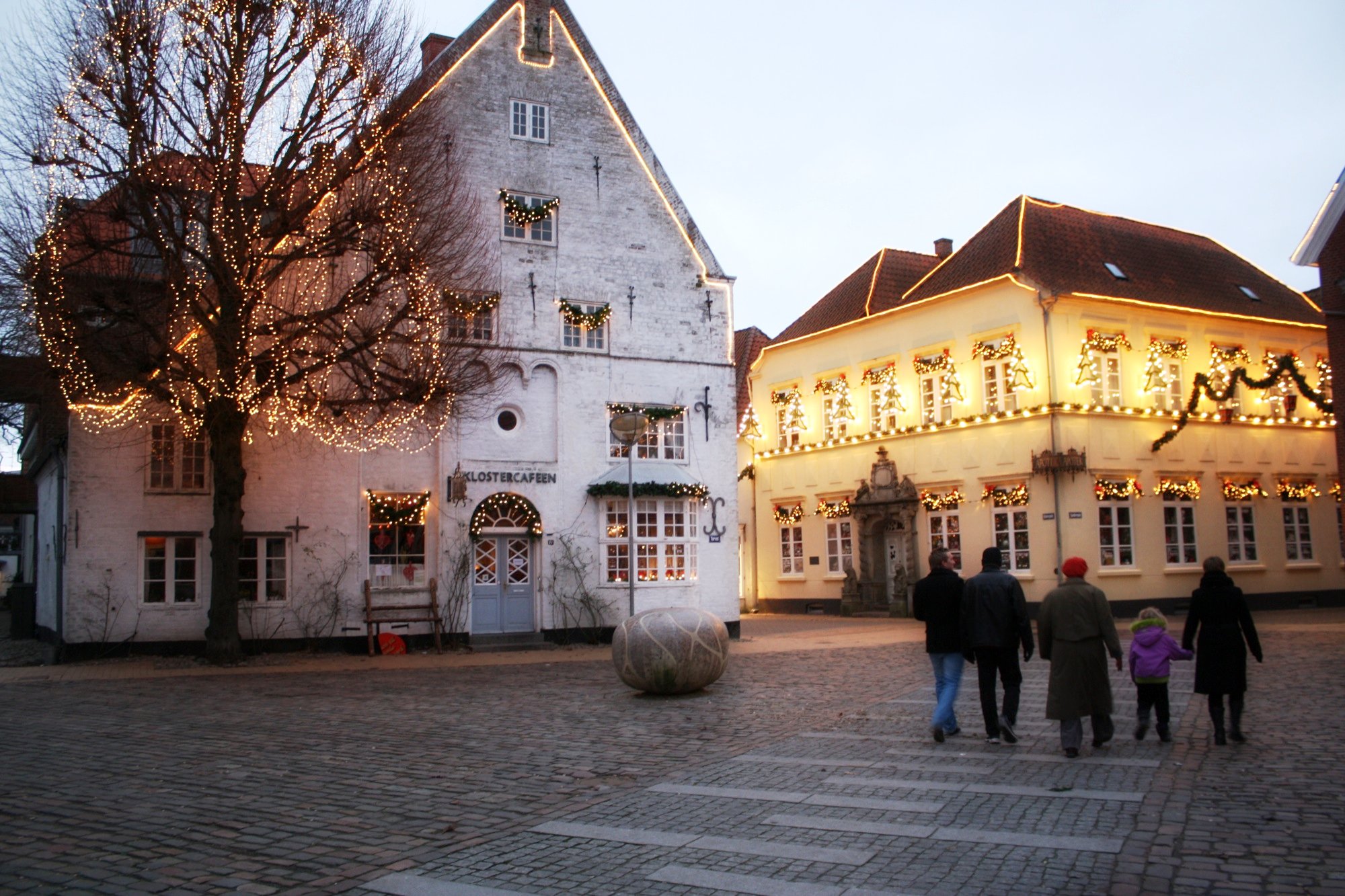 two big white buildings with some lights around them