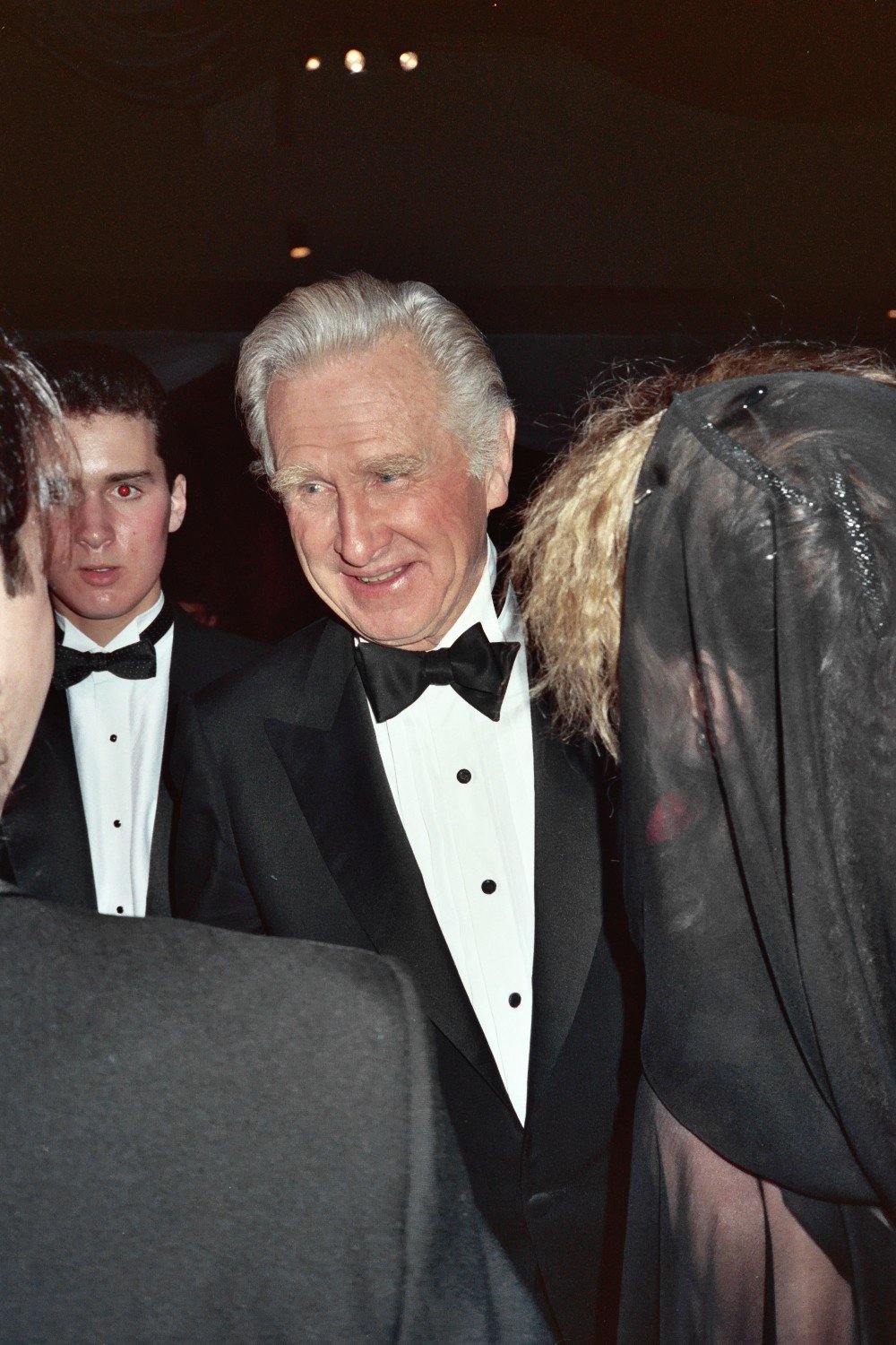 two men in tuxedos are talking to one another