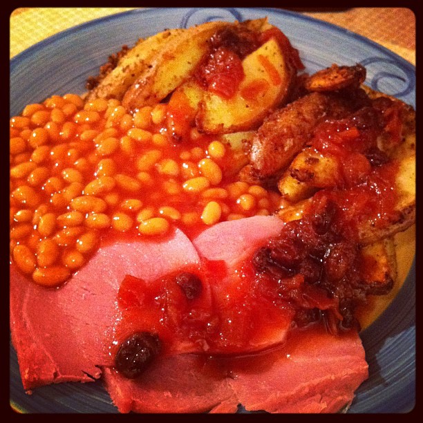 plate of food with meat and beans on it