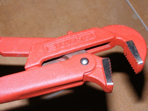 a red tool that is open to show the inside