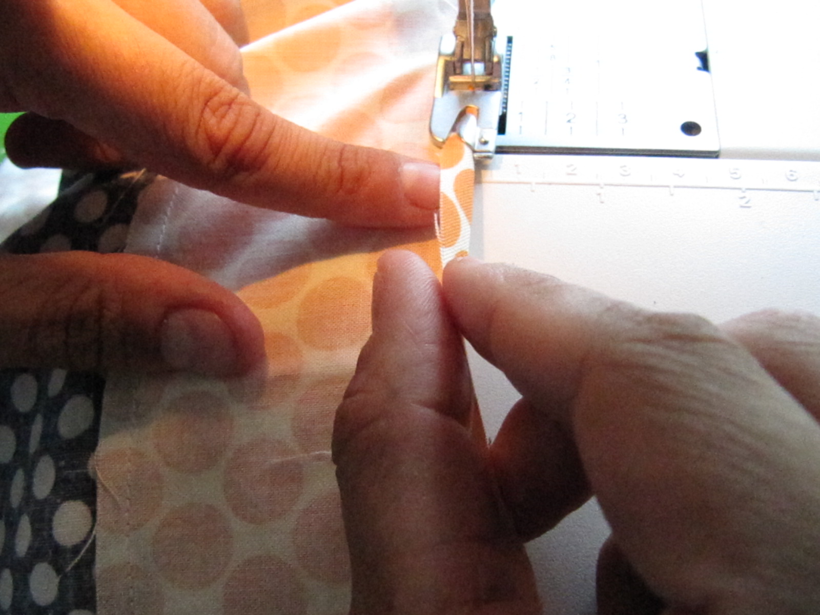 a woman is working on the sewing machine