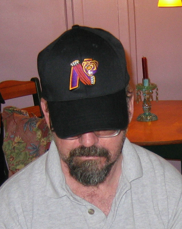 a man wearing a black baseball hat with a tiger patch