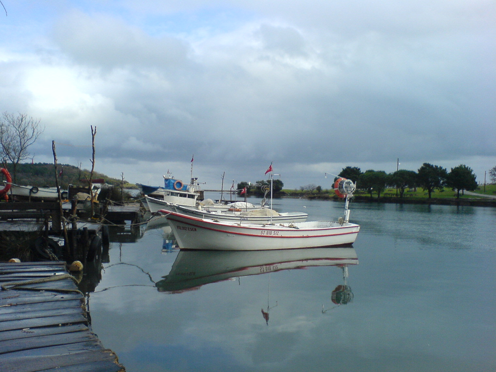 several boats parked at a dock in the water