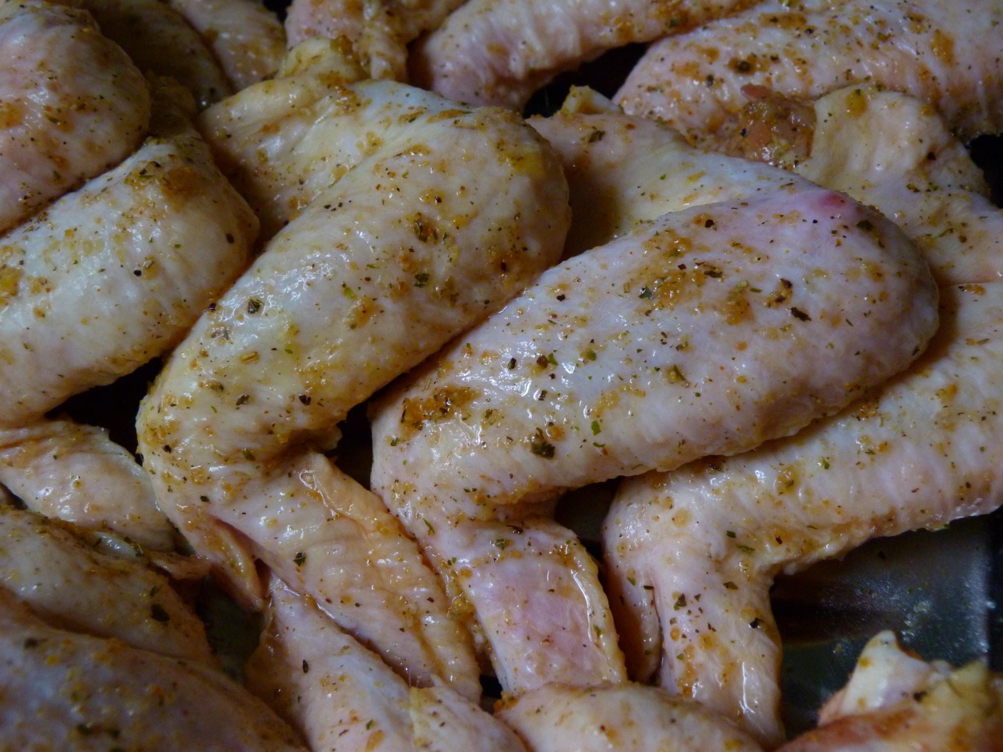 grilled chicken  in a pan covered in seasoning