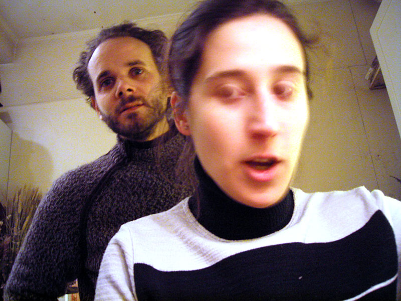 a man and a woman, both wearing turtle neck sweaters