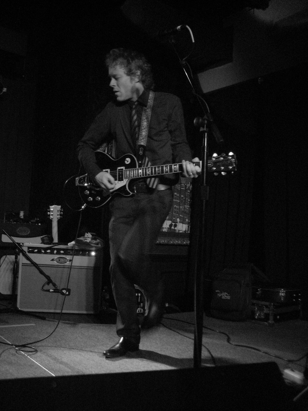 the young man is playing guitar on the stage