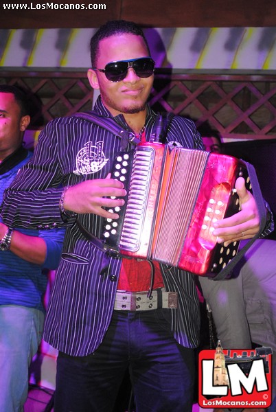 a man with an accordion in front of people