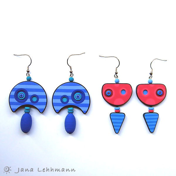 three pairs of earrings designed to look like an airplane with three different colors and shapes