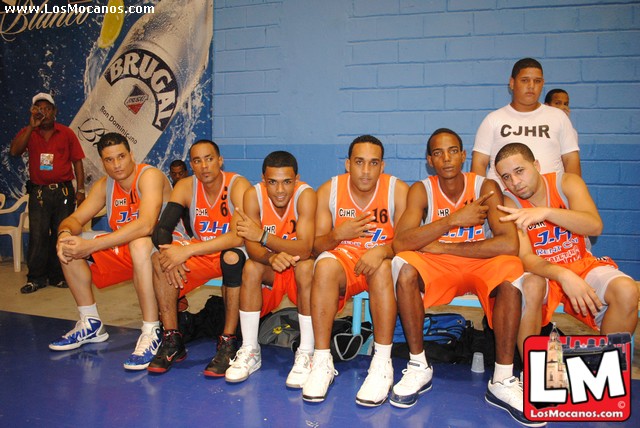 a group of young men in orange basketball uniforms