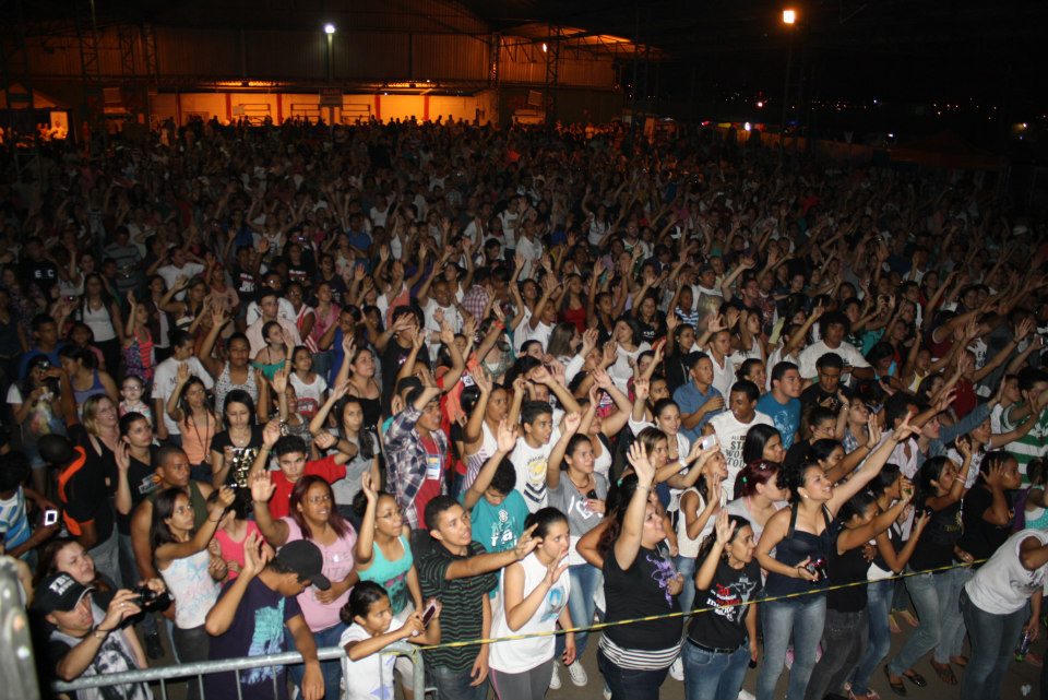 the crowd of people are in front of the fence