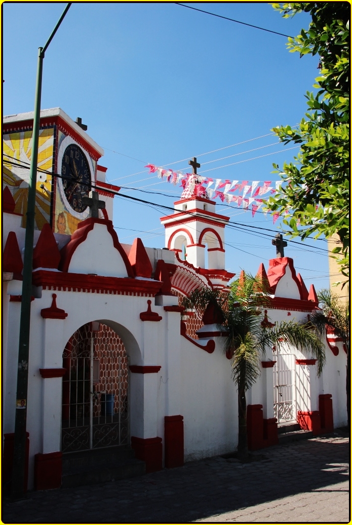 an old building with red trim and yellow trim