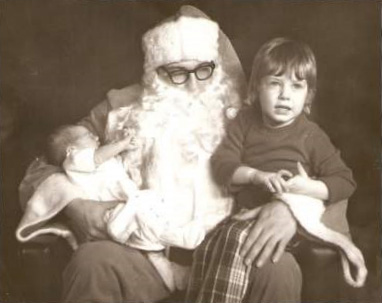 santa clause and child sitting side by side