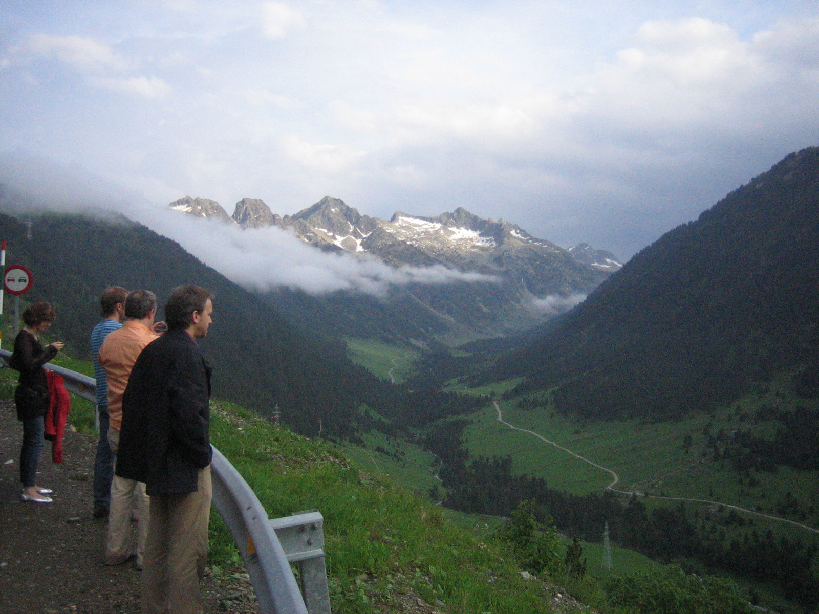 some people overlooking a green mountain range