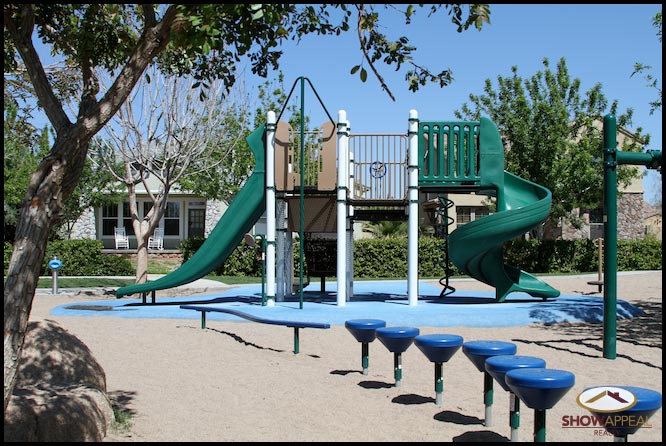 the playground has blue and green plastic benches