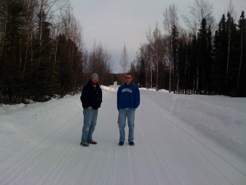 two men on skis standing next to each other