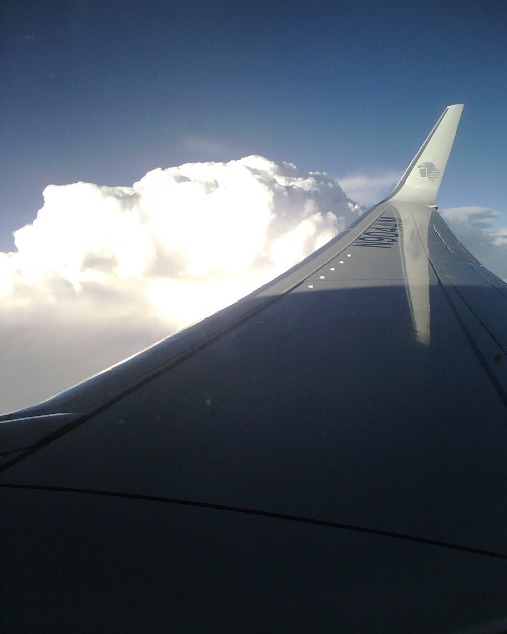 a view from the inside of a plane flying through a cloud filled sky