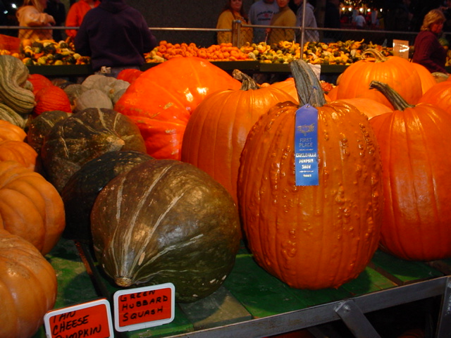 many different types of pumpkins in a store display