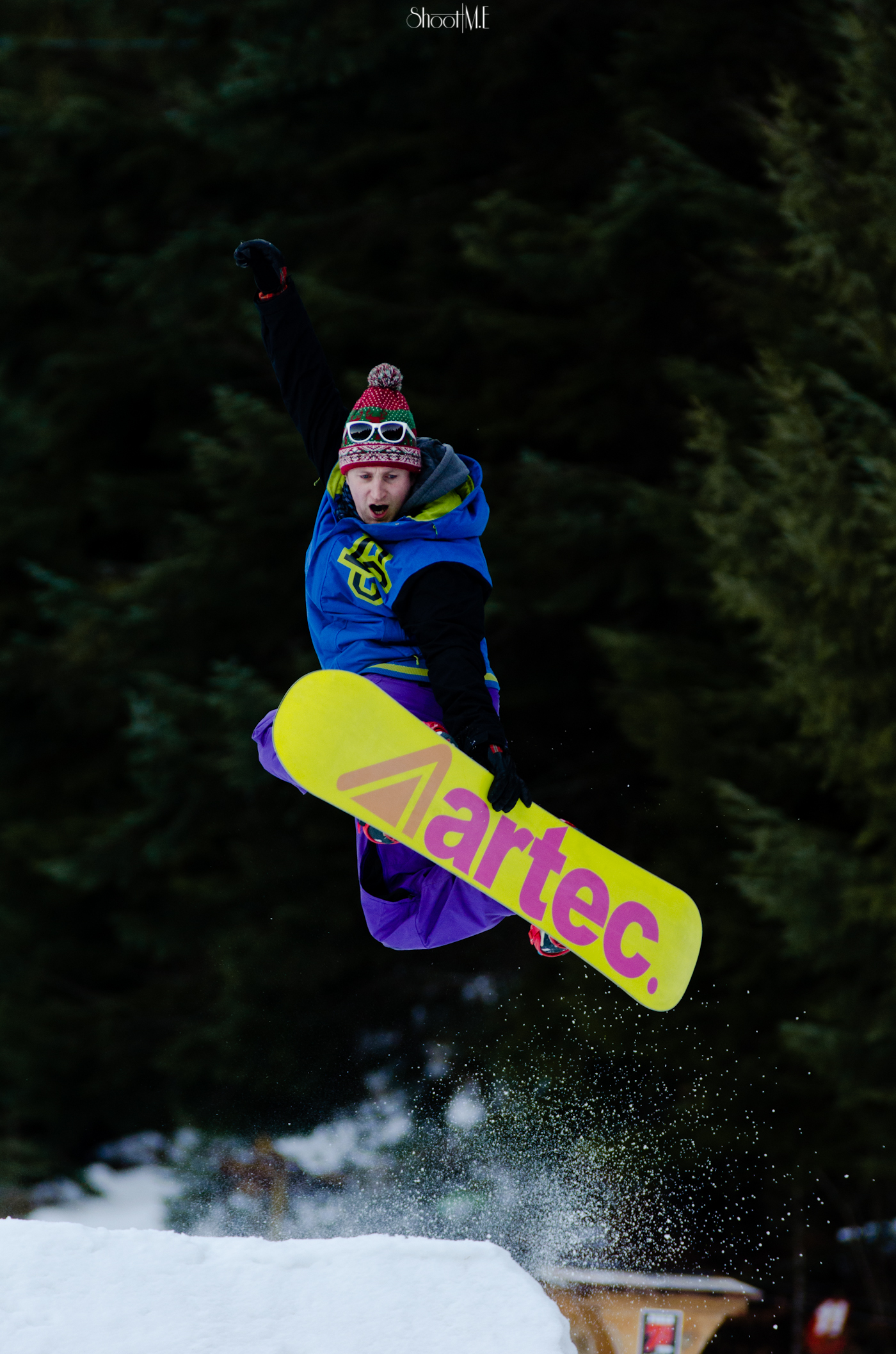 a man who is jumping his snowboard in the air