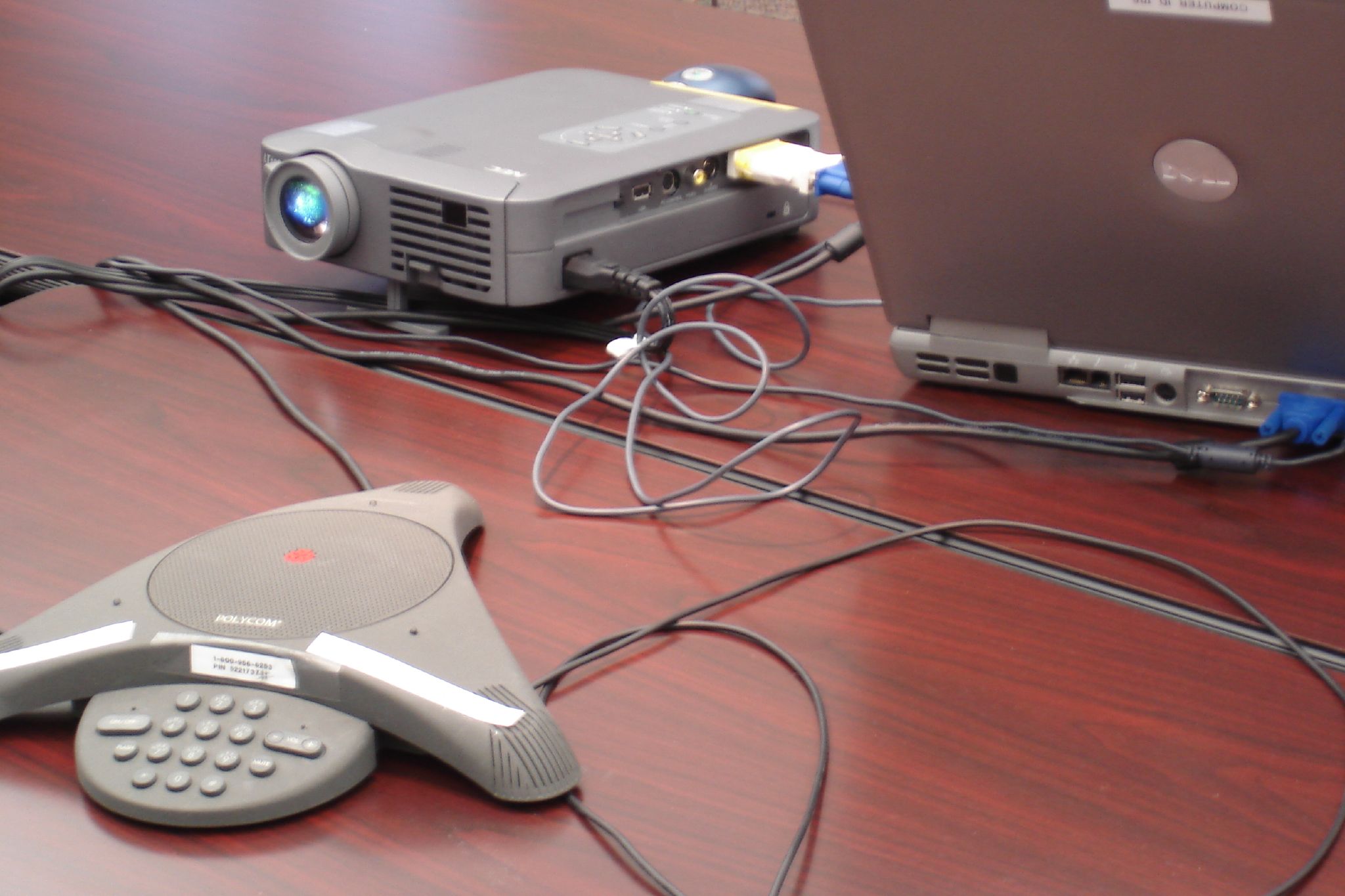 a video conference with two laptops on the desk